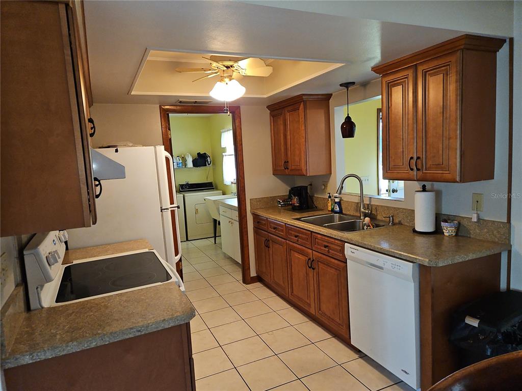 11087 Southwest 77th Court Ocala, FL 34476 - Photo 6 of 31 a kitchen with a sink stove and cabinets