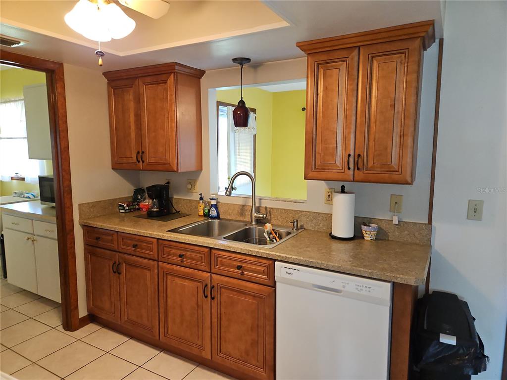 11087 Southwest 77th Court Ocala, FL 34476 - Photo 7 of 31 a kitchen with sink cabinets and window
