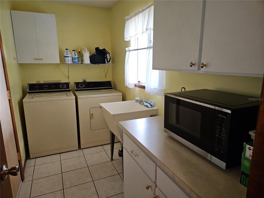 11087 Southwest 77th Court Ocala, FL 34476 - Photo 9 of 31 a kitchen with a sink cabinets and appliances