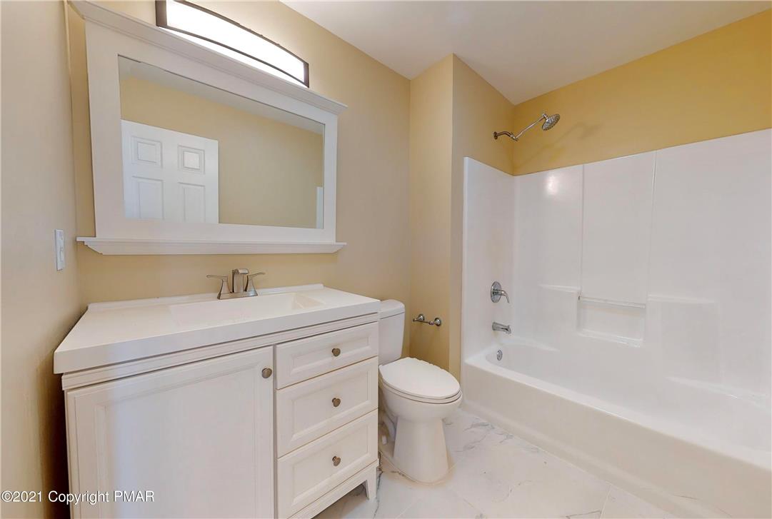 1110 Misty Ridge East Stroudsburg, PA 18302 - Photo 25 of 43 White vanity and bath fixtures anchor this well-appointed washroom, offering crisp lines and functional design.