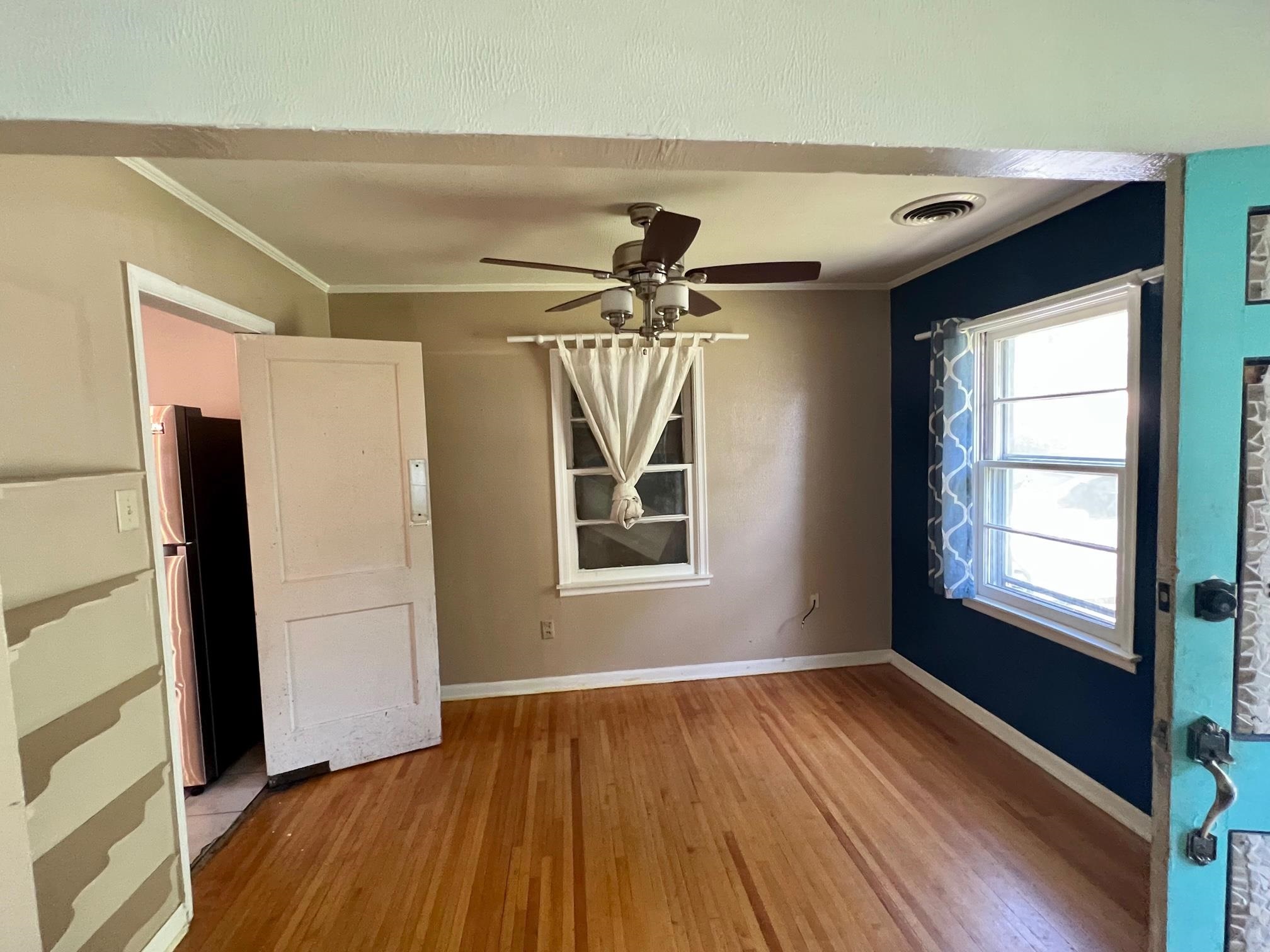 4356 Grey Road Memphis, TN 38108 - Photo 6 of 22 a view of empty room with wooden floor and fan