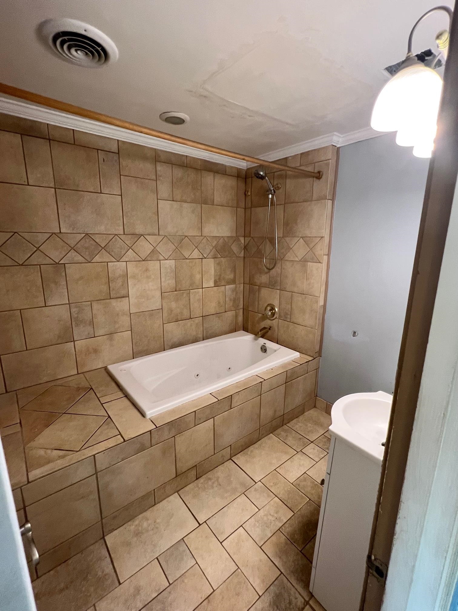 4356 Grey Road Memphis, TN 38108 - Photo 10 of 22 a bathroom with a sink and a shower