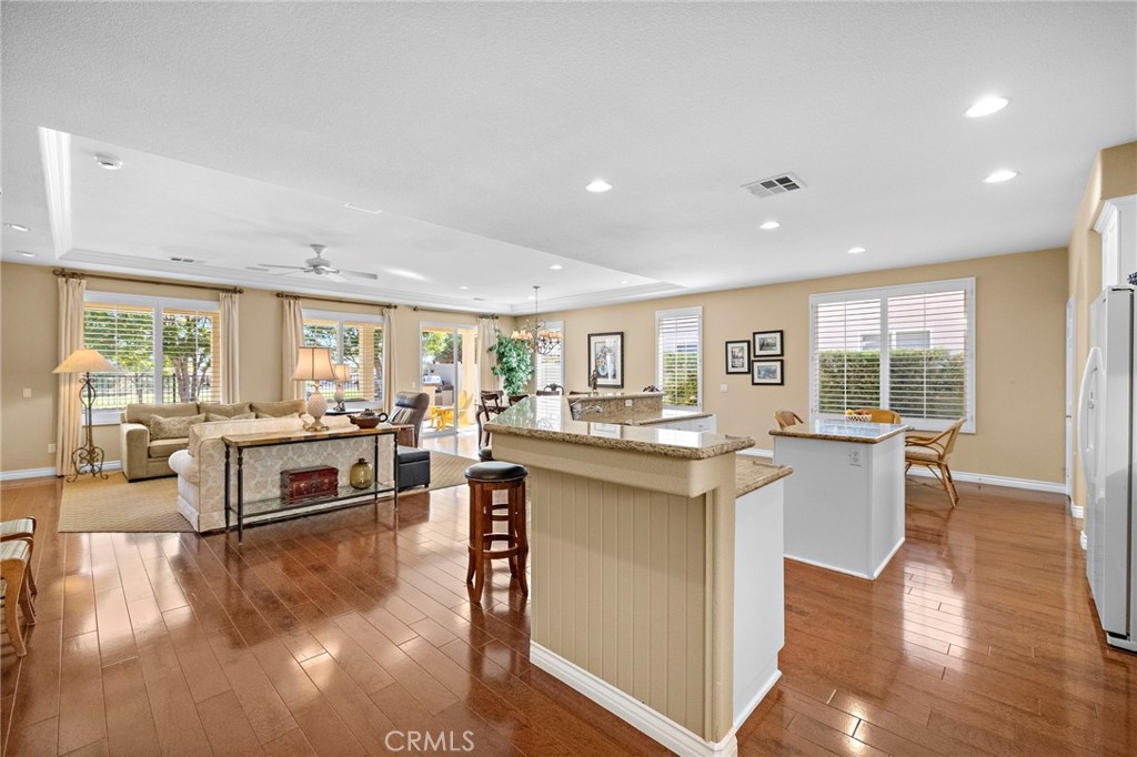 28545 Raintree Drive Menifee, CA 92584 - Photo 13 of 33 a living room with stainless steel appliances granite countertop furniture wooden floor and a large window