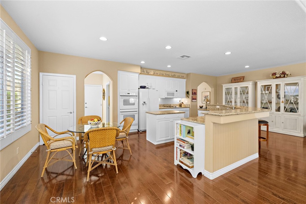 28545 Raintree Drive Menifee, CA 92584 - Photo 14 of 33 a kitchen with a sink cabinets and wooden floor