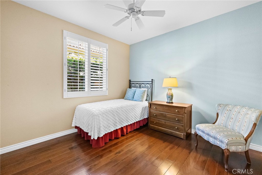 28545 Raintree Drive Menifee, CA 92584 - Photo 19 of 33 a bedroom with a bed and a chandelier