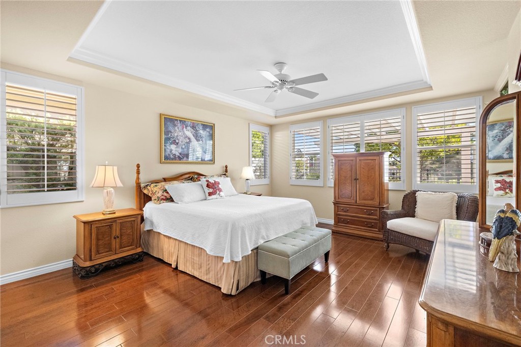 28545 Raintree Drive Menifee, CA 92584 - Photo 22 of 33 a spacious bedroom with a bed couch and a large window