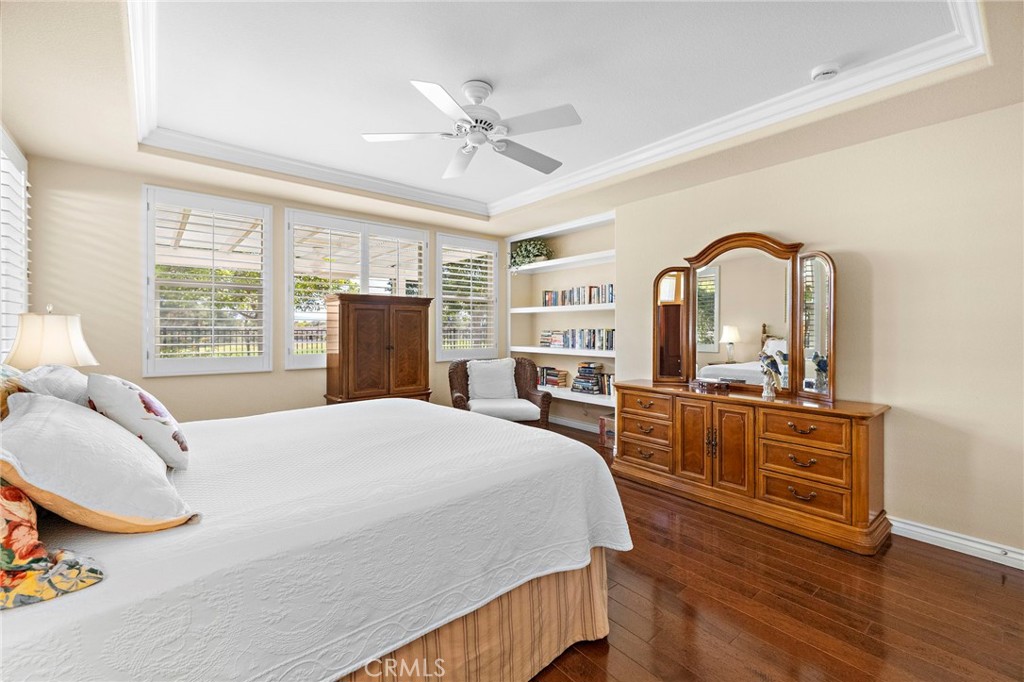 28545 Raintree Drive Menifee, CA 92584 - Photo 24 of 33 a bedroom with a bed a dresser and wooden floor