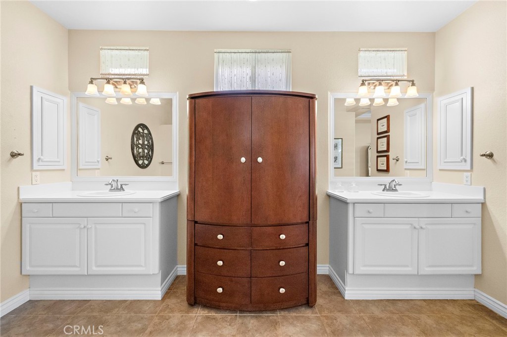 28545 Raintree Drive Menifee, CA 92584 - Photo 25 of 33 a bathroom with a sink double vanity and a mirror