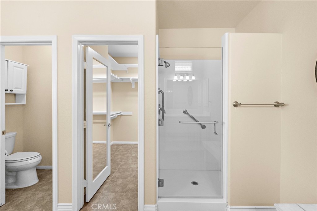 28545 Raintree Drive Menifee, CA 92584 - Photo 26 of 33 a bathroom with a glass shower door