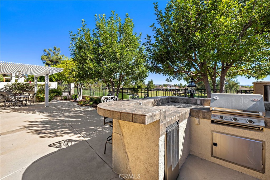 28545 Raintree Drive Menifee, CA 92584 - Photo 29 of 33 a view of a kitchen with a stove and cabinets