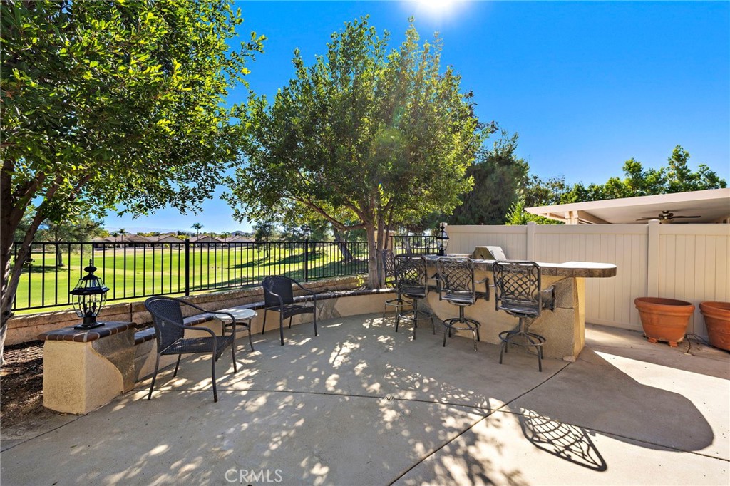 28545 Raintree Drive Menifee, CA 92584 - Photo 30 of 33 an outdoor sitting area with couch and wooden fence