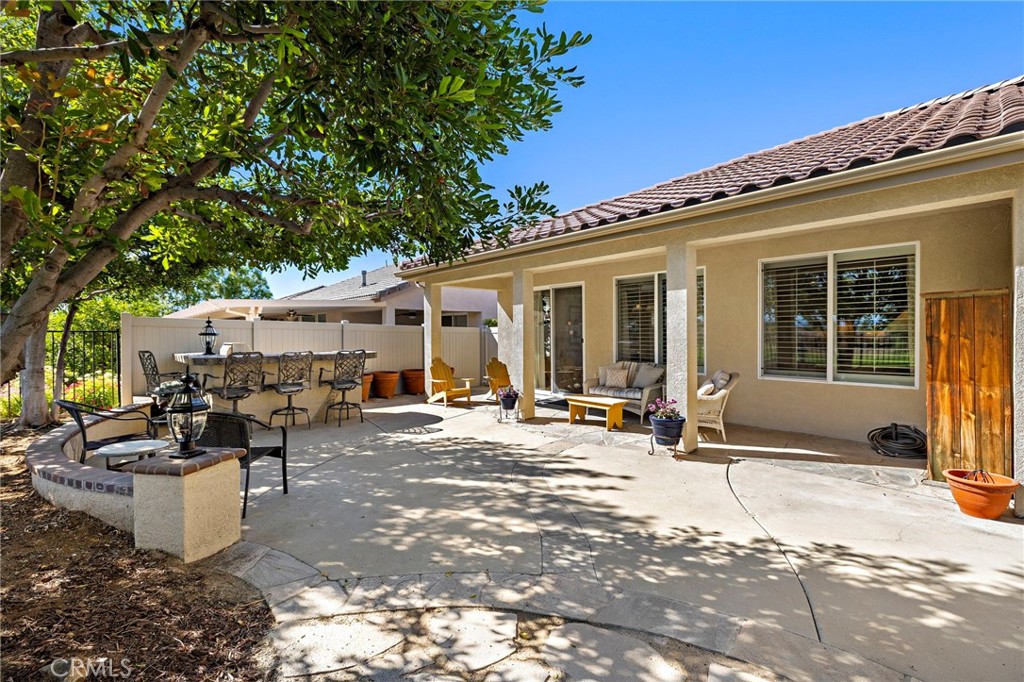 28545 Raintree Drive Menifee, CA 92584 - Photo 32 of 33 a view of a patio with table and chairs and potted plants