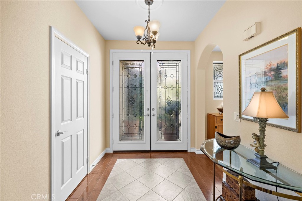 28545 Raintree Drive Menifee, CA 92584 - Photo 5 of 33 a view of a livingroom with wooden floor and chandelier