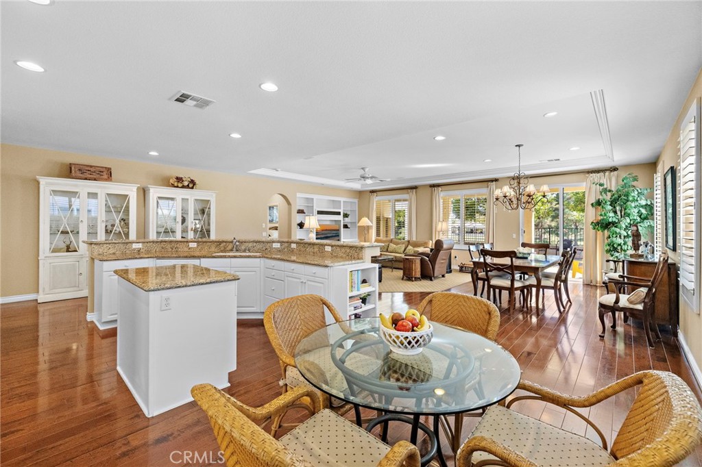 28545 Raintree Drive Menifee, CA 92584 - Photo 9 of 33 a living room with furniture a dining table and kitchen view