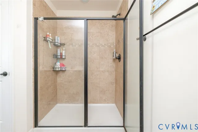 a living room with furniture a book shelf and a window