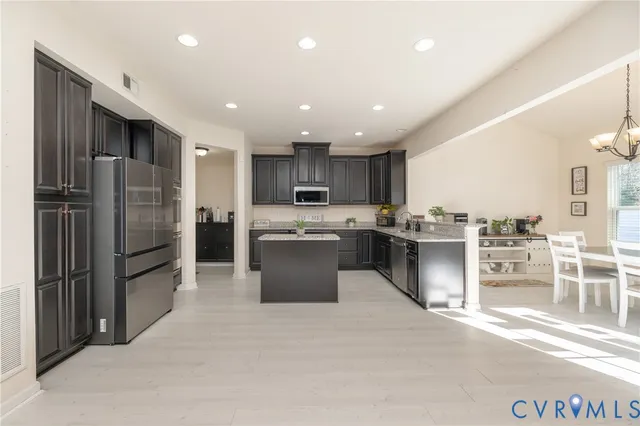 a kitchen with a refrigerator and microwave