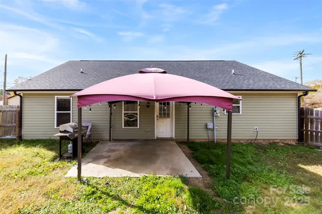 a patio with table and chairs under an umbrella