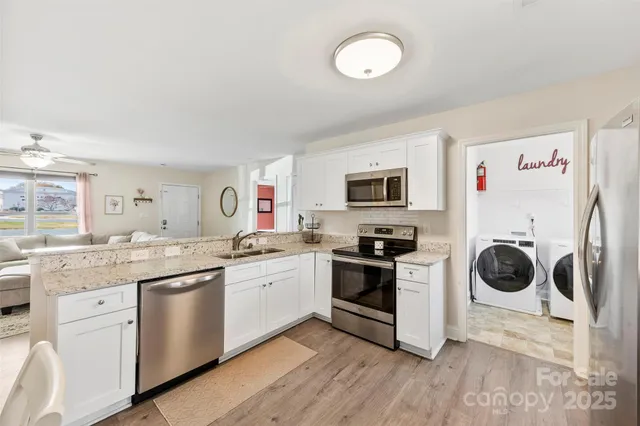 a kitchen with a sink stove and white cabinets
