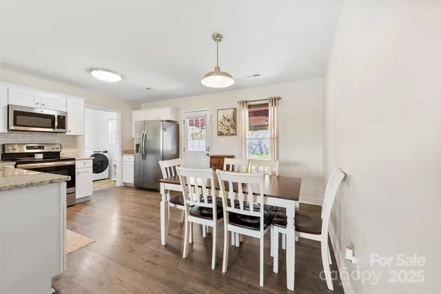a view of a dining room with furniture window and wooden floor