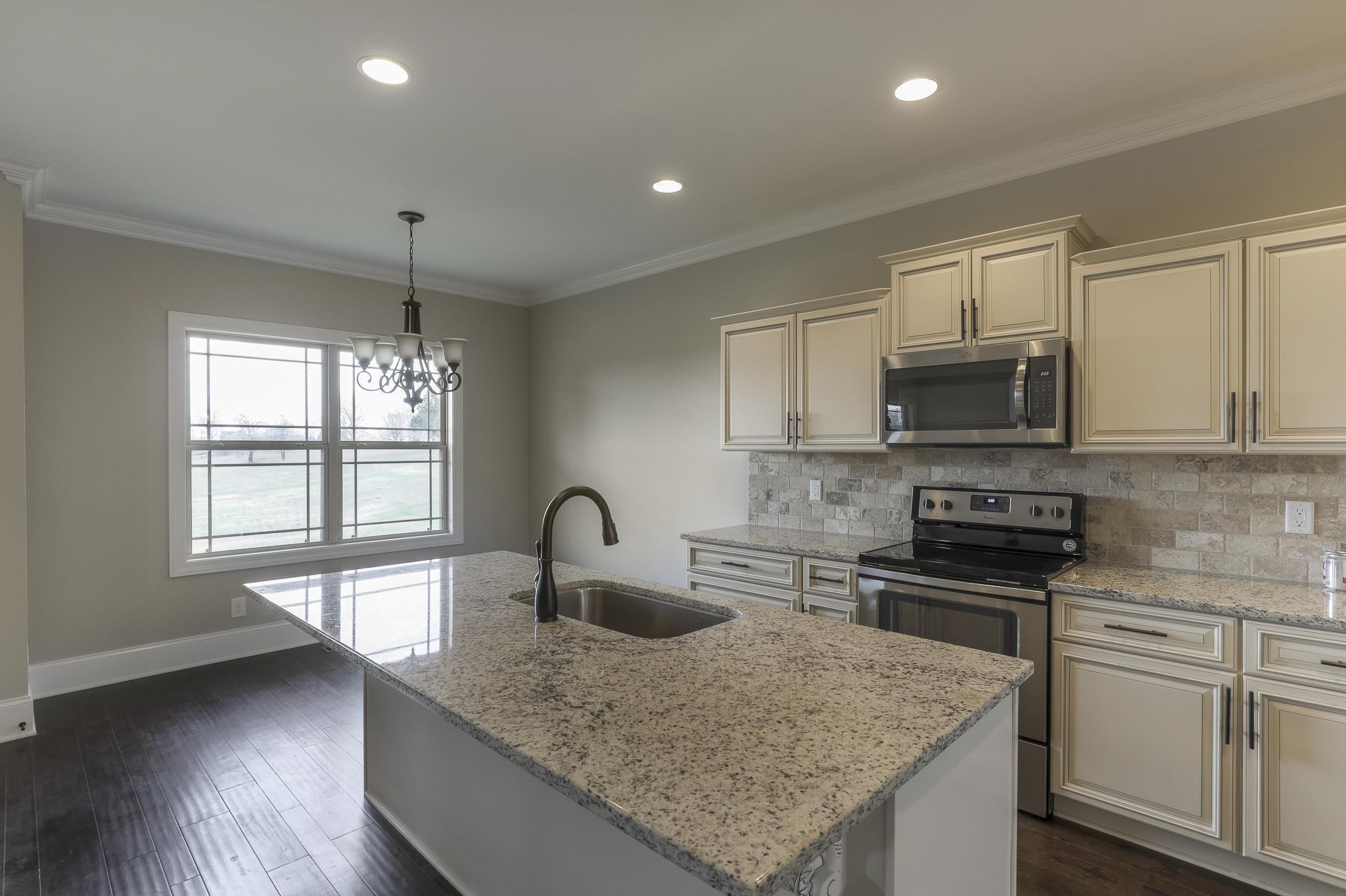 254 Bates Road Lebanon, TN 37087 - Photo 10 of 20 a kitchen with stainless steel appliances granite countertop a sink stove and refrigerator