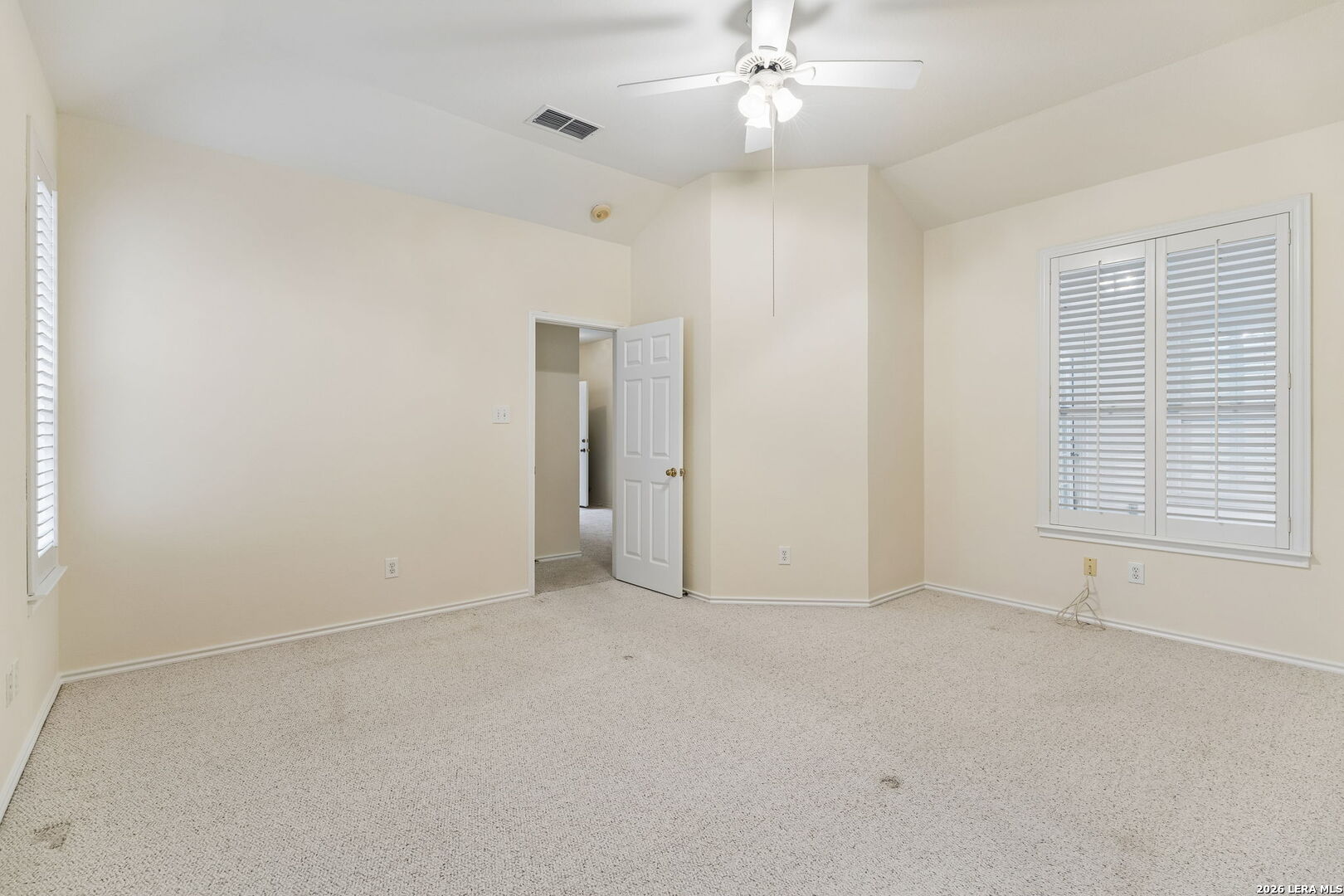 15314 Spring Land San Antonio, TX 78247 - Photo 12 of 49 en empty room with windows and chandelier fan