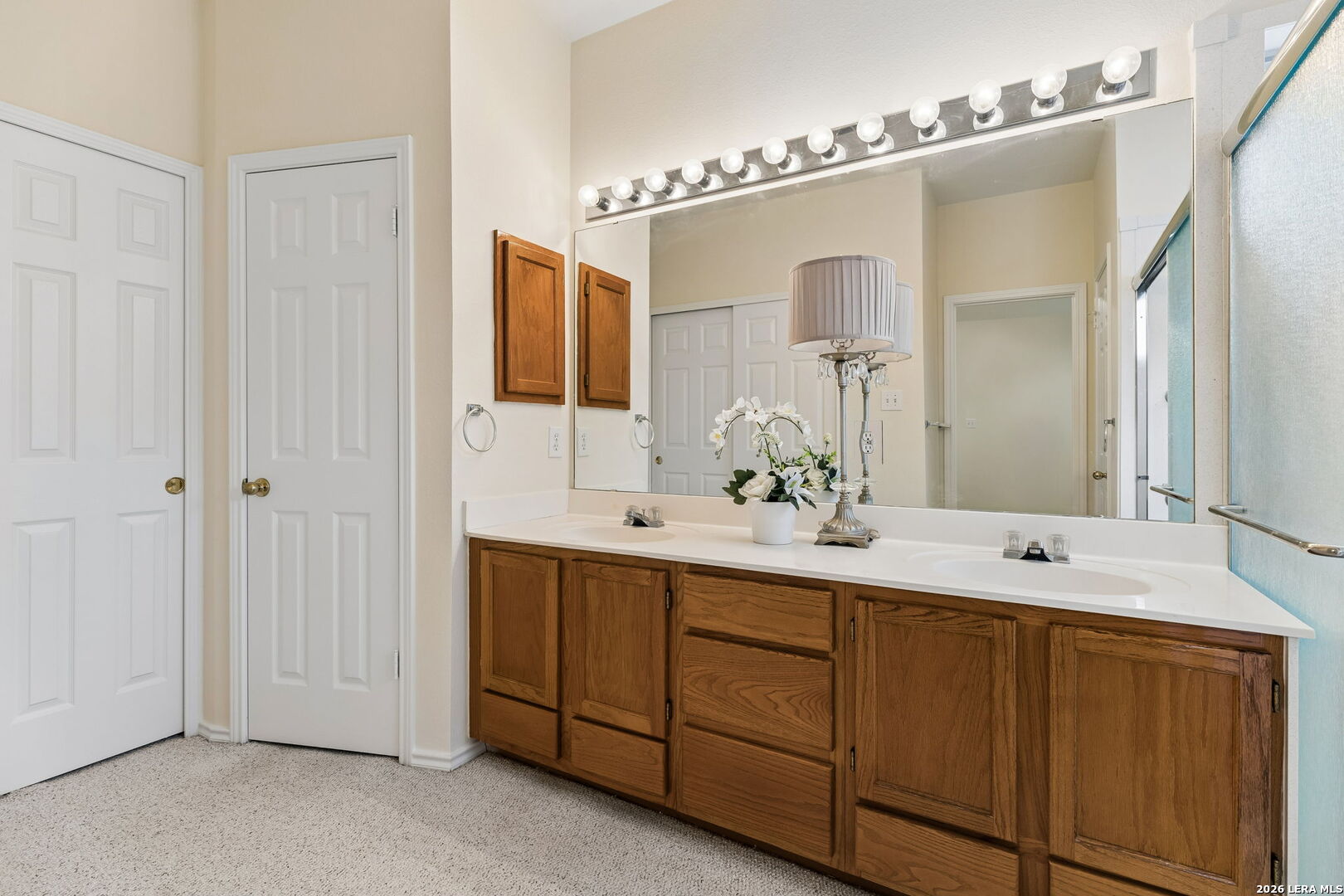 15314 Spring Land San Antonio, TX 78247 - Photo 13 of 49 a bathroom with a double vanity sink and mirror