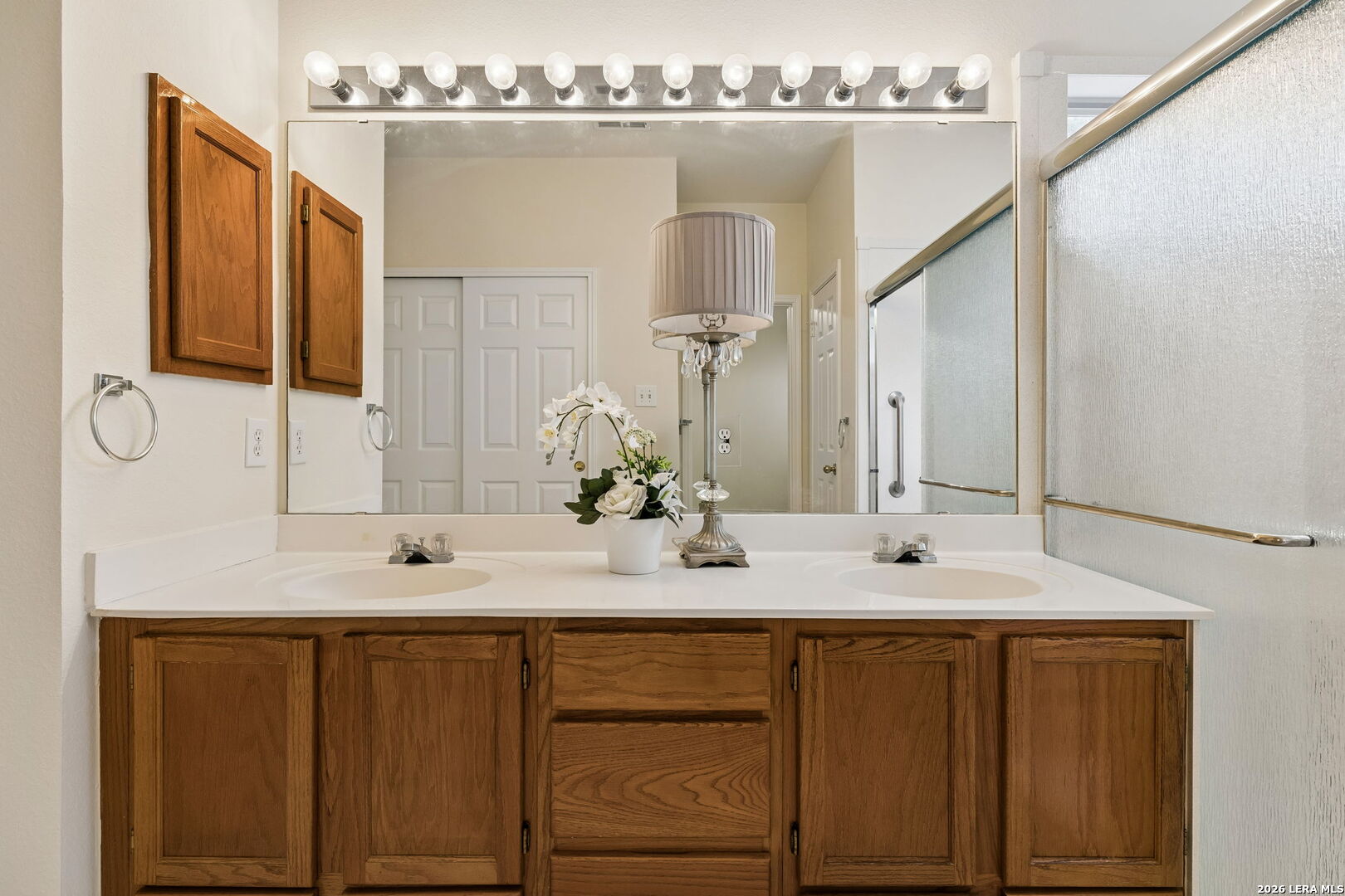 15314 Spring Land San Antonio, TX 78247 - Photo 14 of 49 a bathroom with a double vanity sink and a mirror