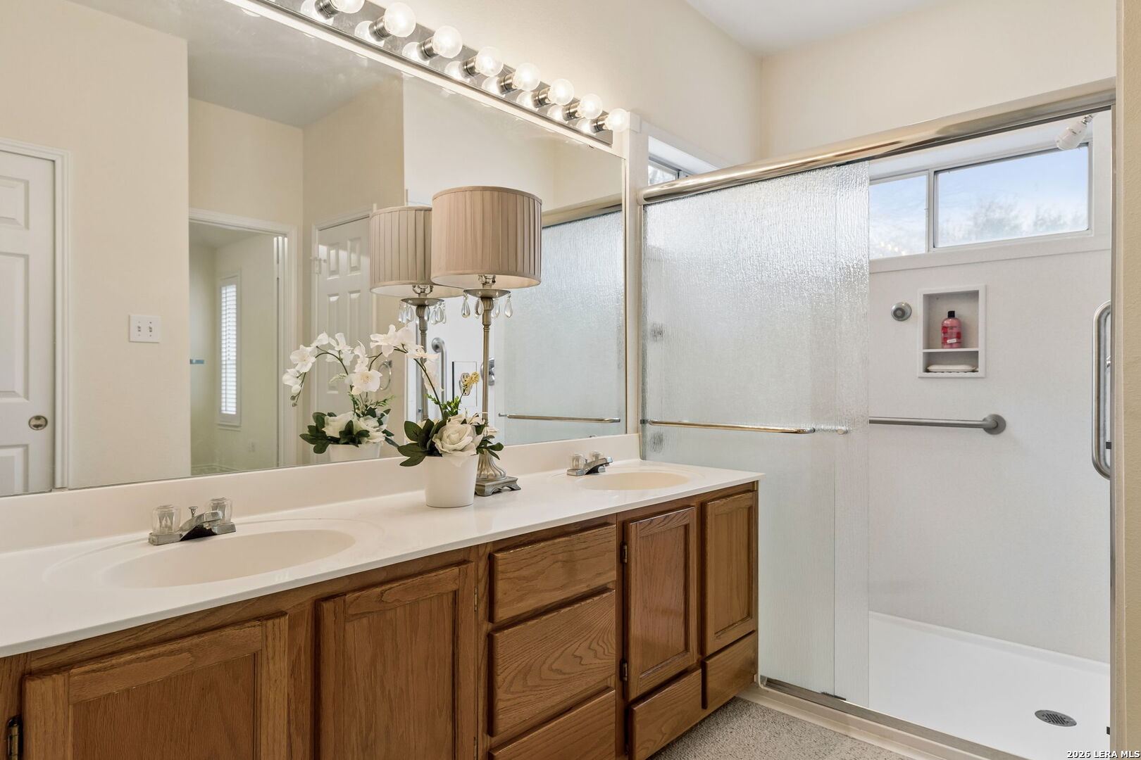 15314 Spring Land San Antonio, TX 78247 - Photo 15 of 49 a bathroom with a double vanity sink a mirror and shower