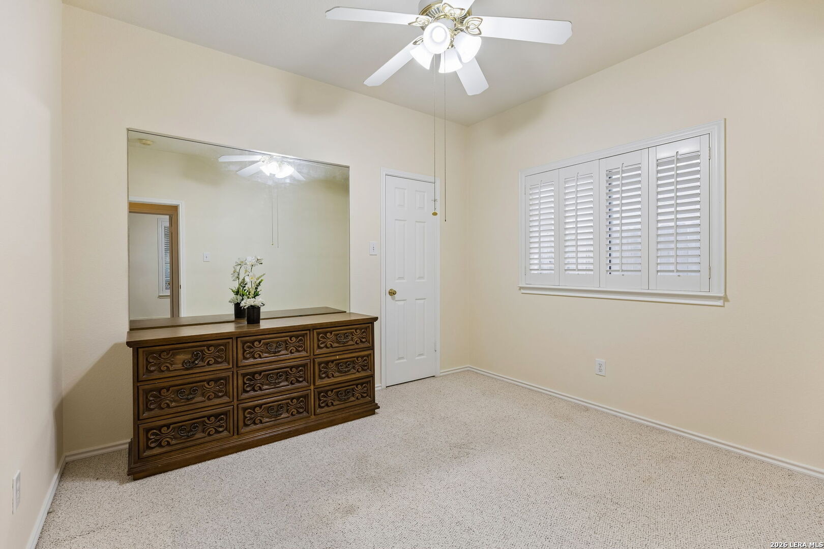 15314 Spring Land San Antonio, TX 78247 - Photo 16 of 49 a spacious bedroom with a dresser and a chandelier