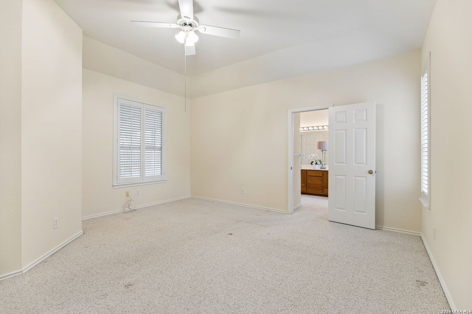 15314 Spring Land San Antonio, TX 78247 - Photo 9 of 49 an empty room with chandelier fan and windows