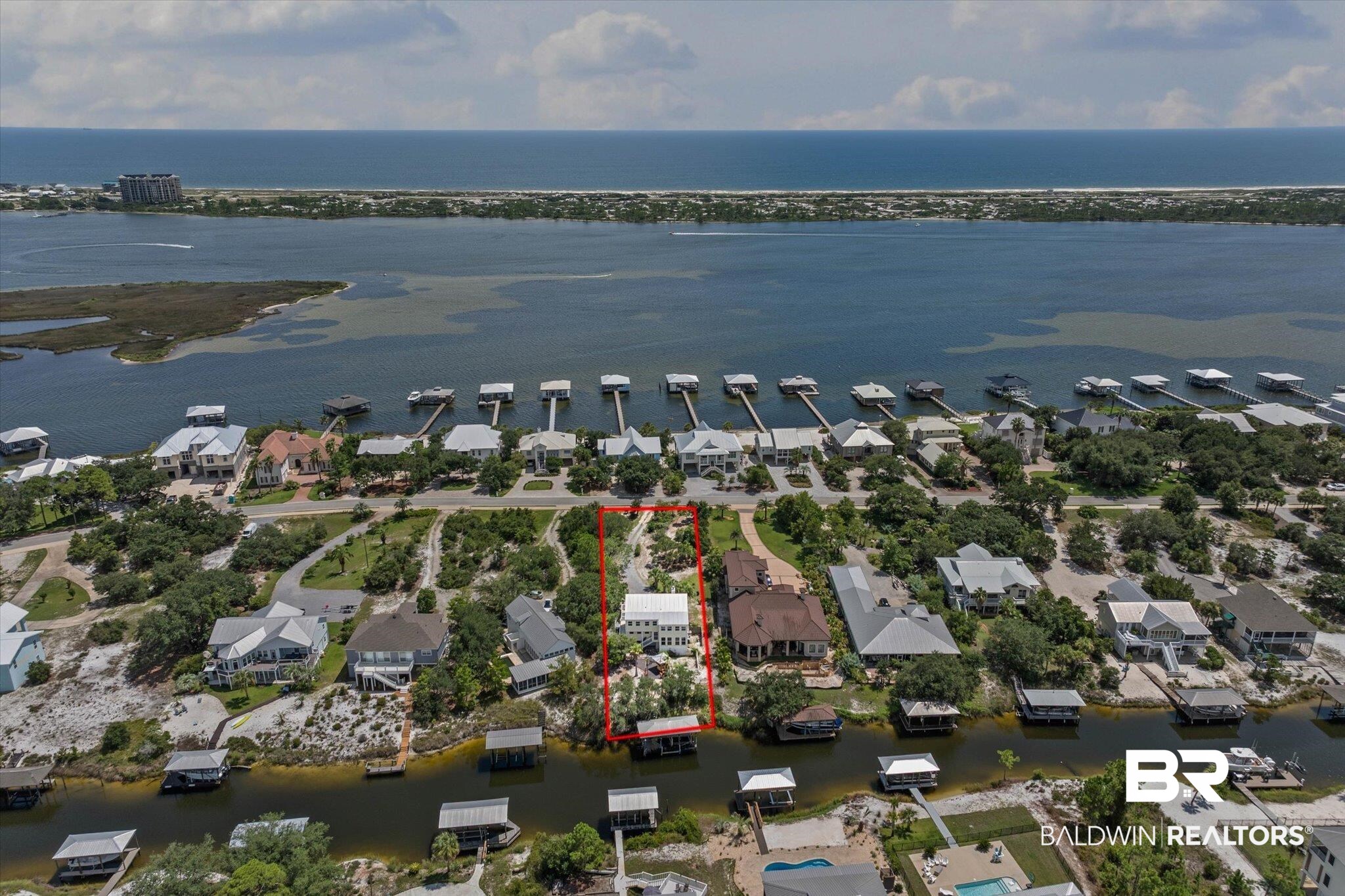 33129 River Road Orange Beach, AL 36561 - Photo 24 of 34 Aerial perspective of suburban area featuring a large body of water and property parcel outlined