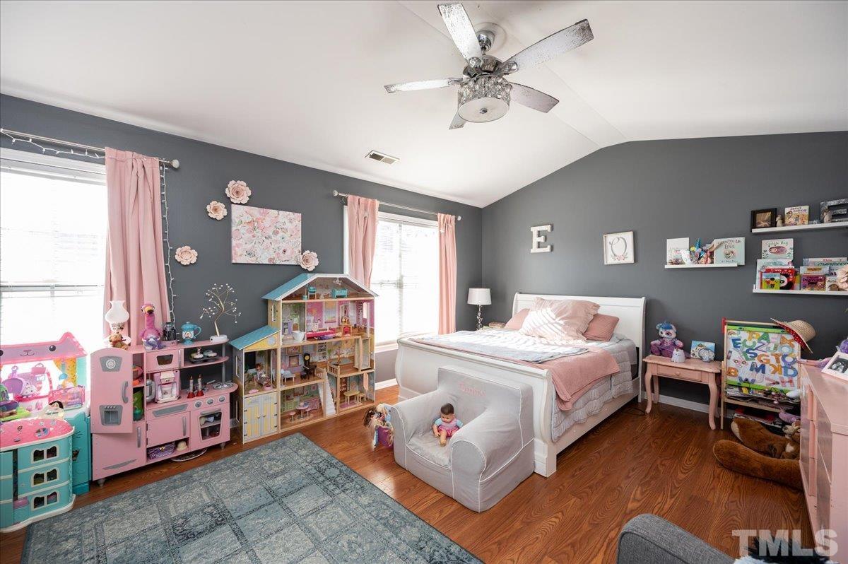 5542 Red Robin Road Raleigh, NC 27613 - Photo 18 of 23 a bed room with a bed window and a chair