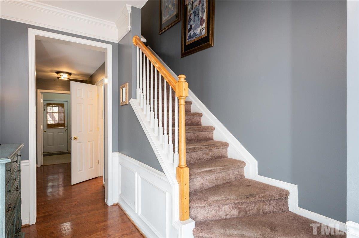 5542 Red Robin Road Raleigh, NC 27613 - Photo 5 of 23 a view of entryway and hall with wooden floor
