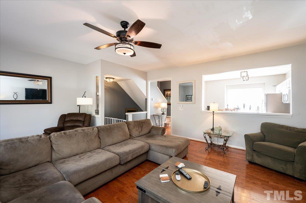 5542 Red Robin Road Raleigh, NC 27613 - Photo 8 of 23 a living room with furniture and wooden floor