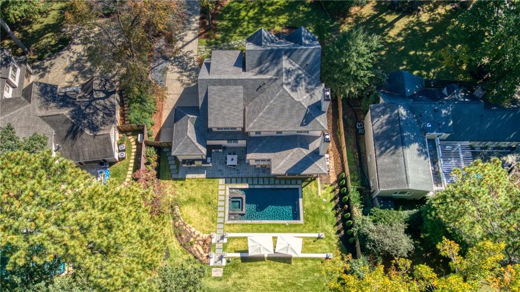 front view of a house with a small yard and large tree