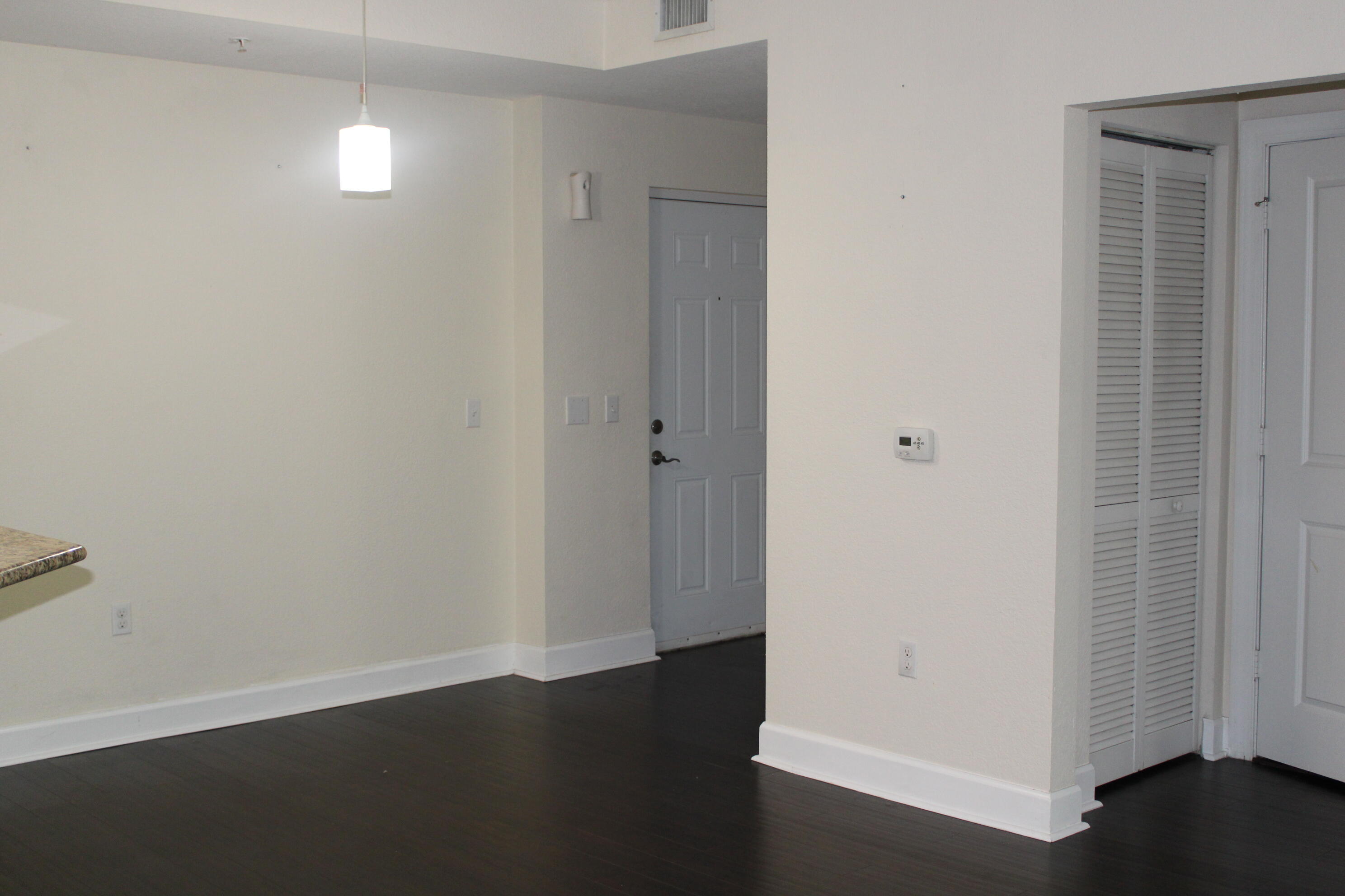 1690 Renaissance Commons Boulevard, Unit 1429 Boynton Beach, FL 33426 - Photo 15 of 23 an empty room with wooden floor