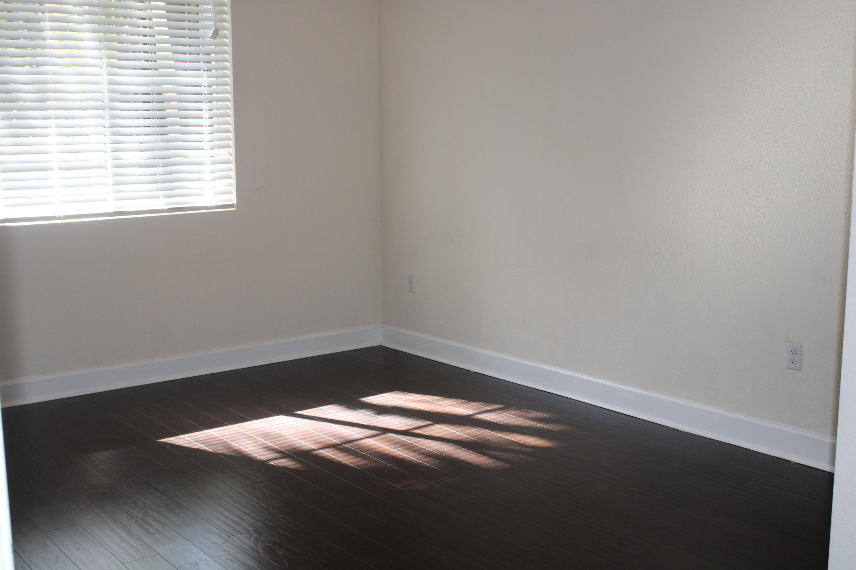 1690 Renaissance Commons Boulevard, Unit 1429 Boynton Beach, FL 33426 - Photo 17 of 23 a view of a small space with wooden floor and a window