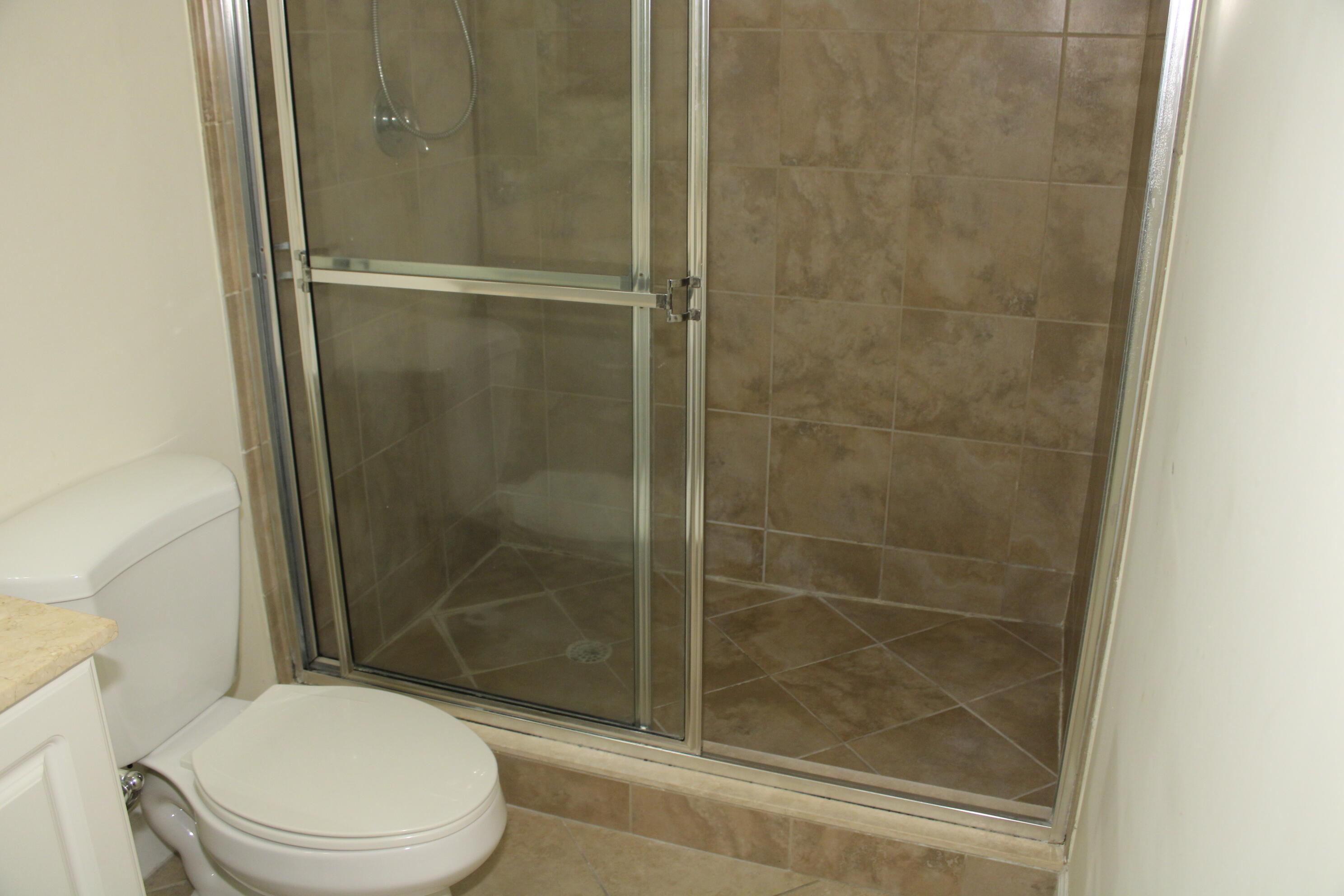 1690 Renaissance Commons Boulevard, Unit 1429 Boynton Beach, FL 33426 - Photo 19 of 23 a bathroom with a shower and a toilet