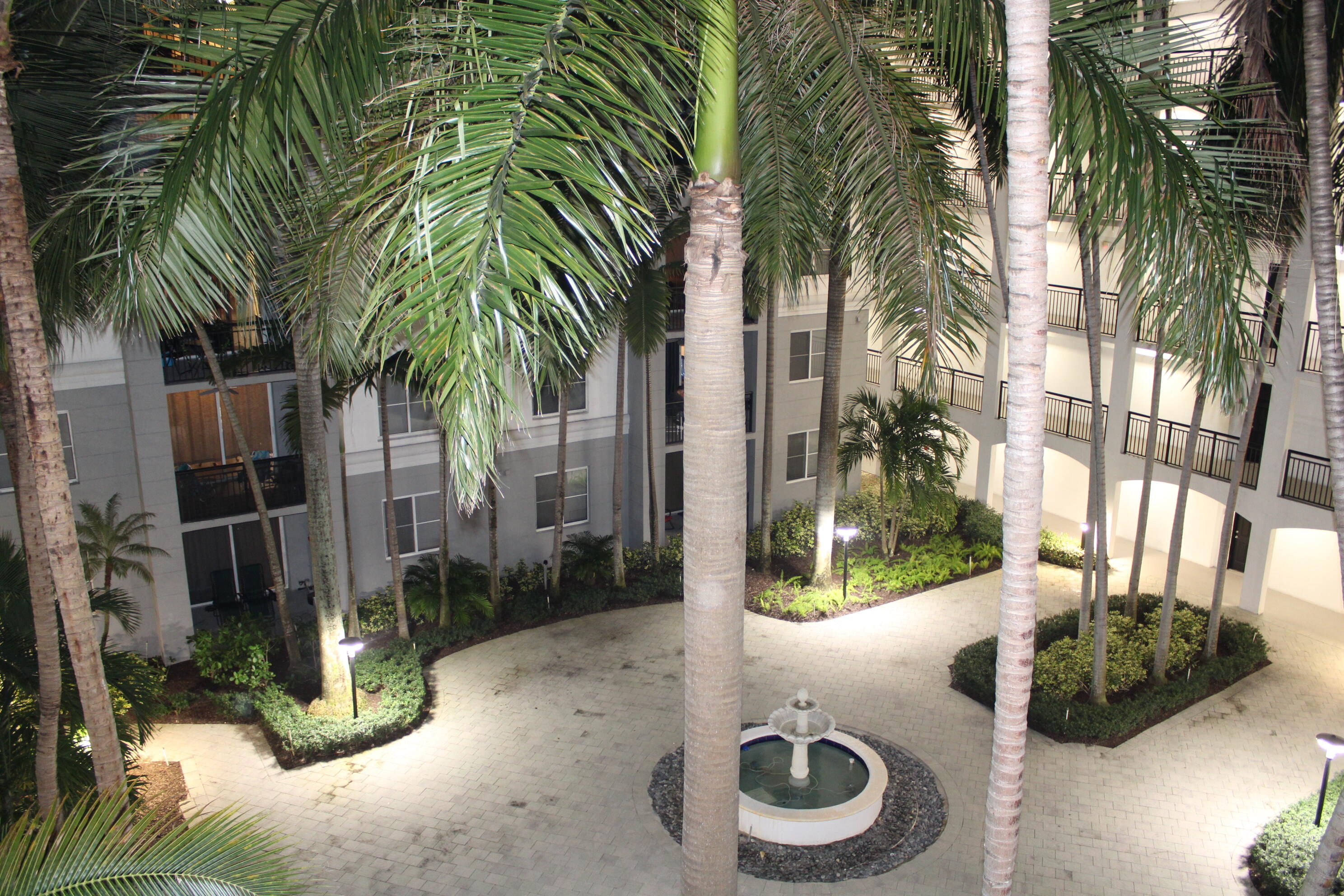 1690 Renaissance Commons Boulevard, Unit 1429 Boynton Beach, FL 33426 - Photo 23 of 23 a backyard of a house with fountain and entertaining space