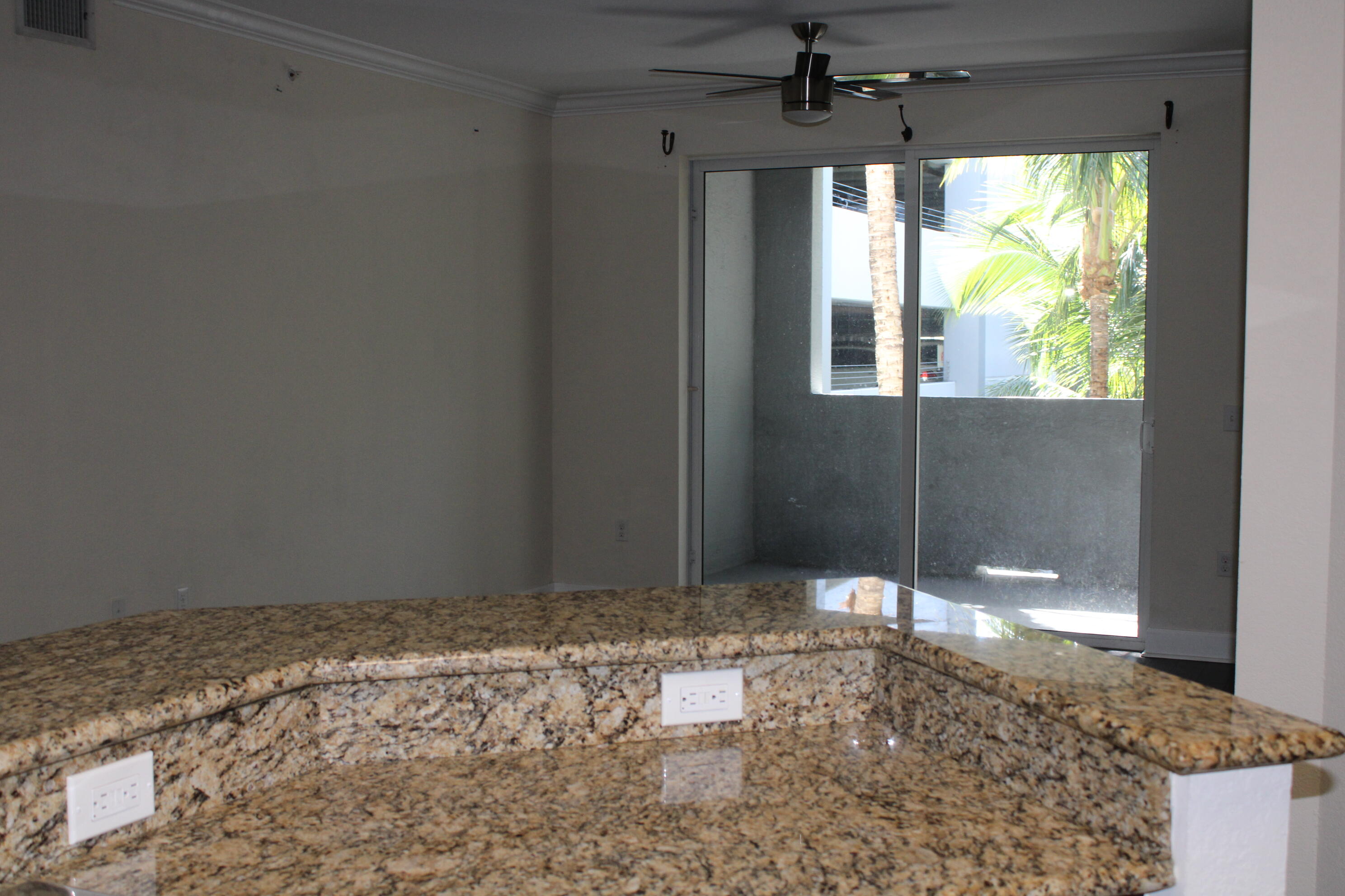 1690 Renaissance Commons Boulevard, Unit 1429 Boynton Beach, FL 33426 - Photo 5 of 23 a view of an empty room with a window