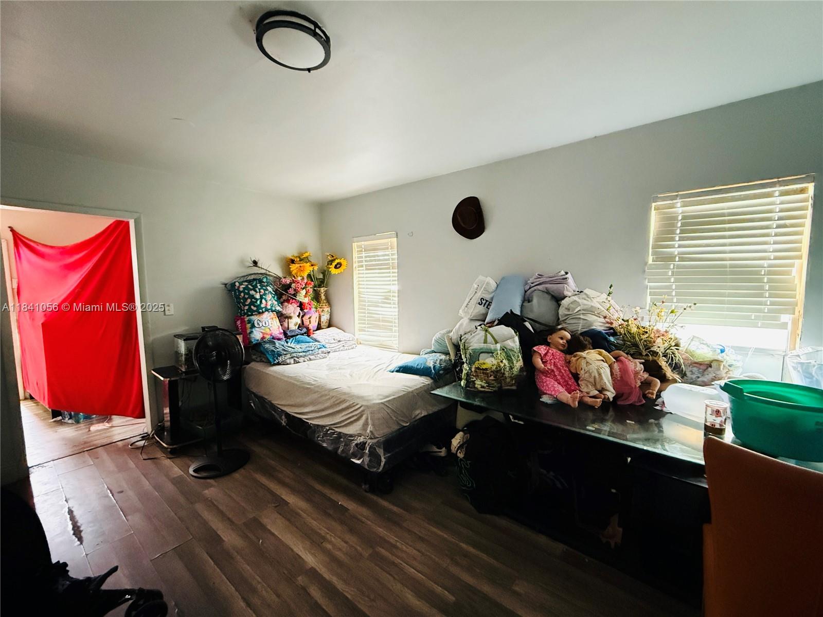 1873 Southwest 3rd Street Miami, FL 33135 - Photo 12 of 18 a bedroom with a bed closet and window