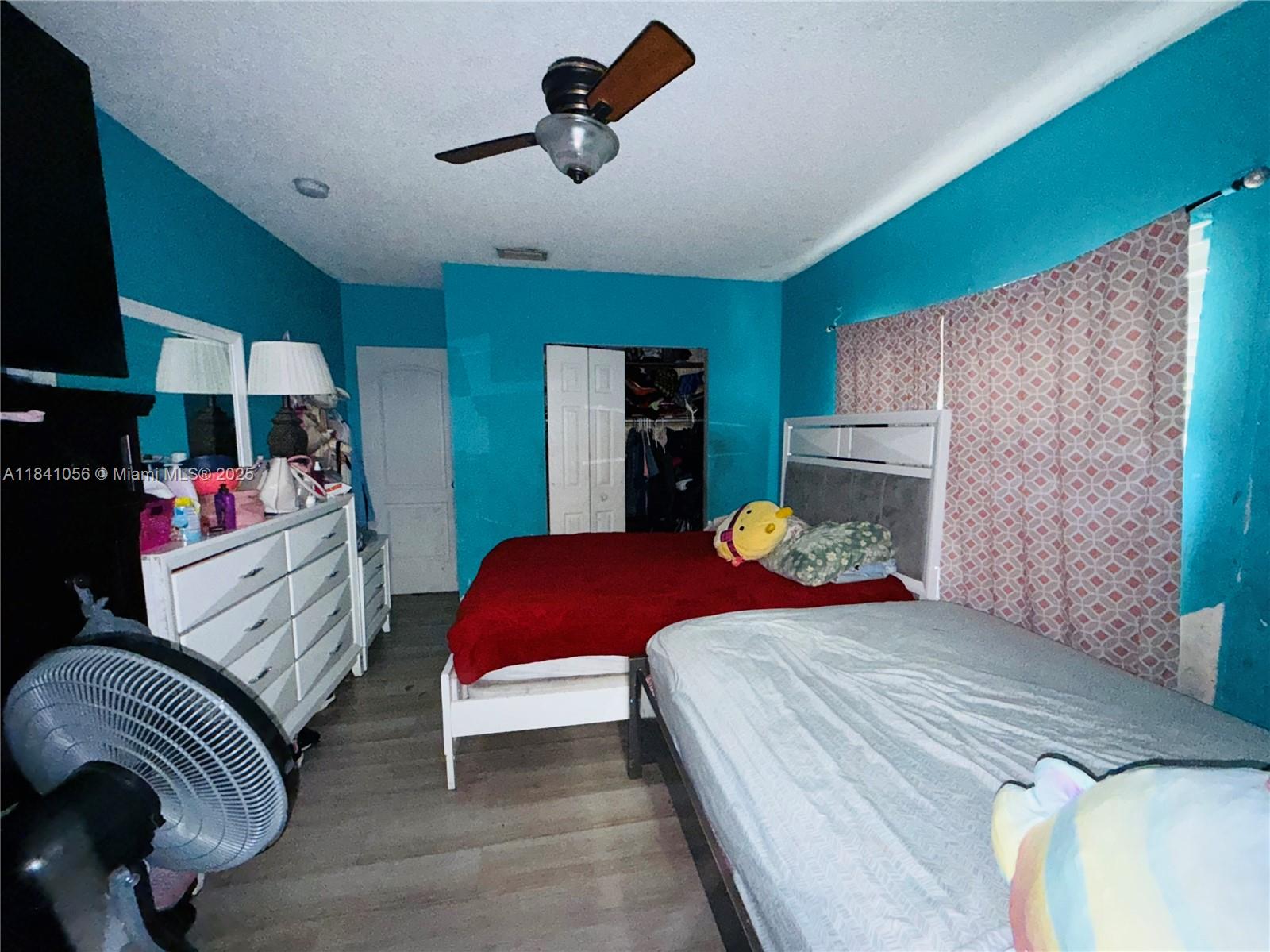 1873 Southwest 3rd Street Miami, FL 33135 - Photo 13 of 18 a bedroom with a bed and a chandelier