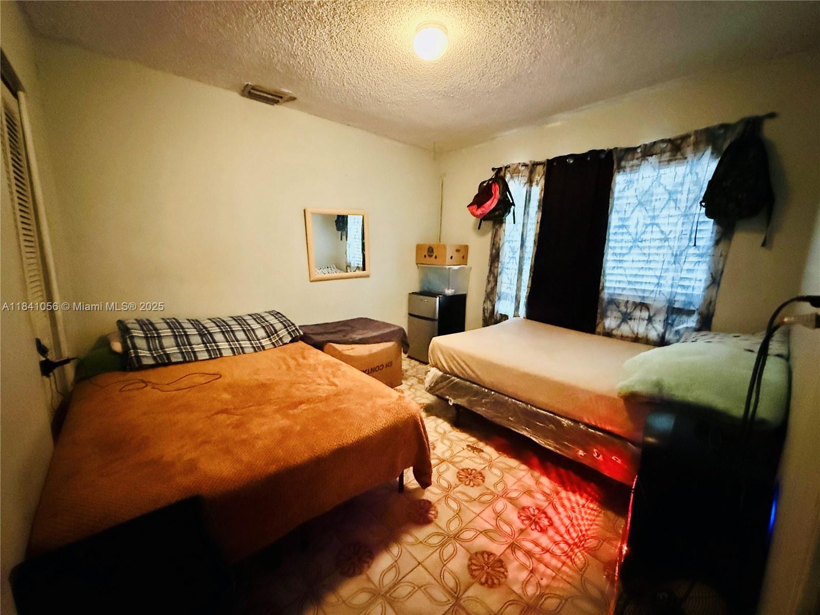 1873 Southwest 3rd Street Miami, FL 33135 - Photo 15 of 18 a bedroom with bed and window