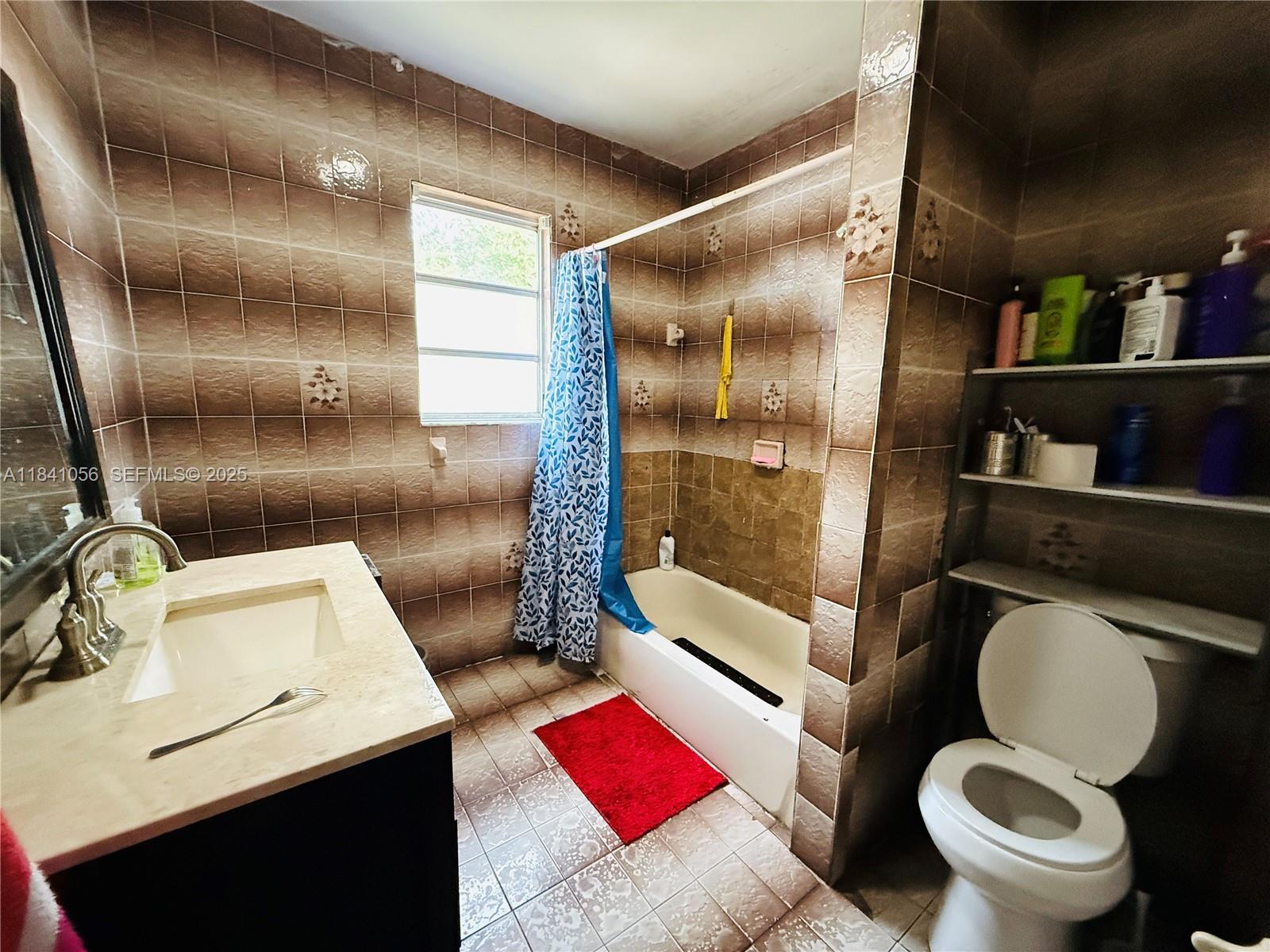 1873 Southwest 3rd Street Miami, FL 33135 - Photo 16 of 18 a white toilet sitting next to a bathroom sink