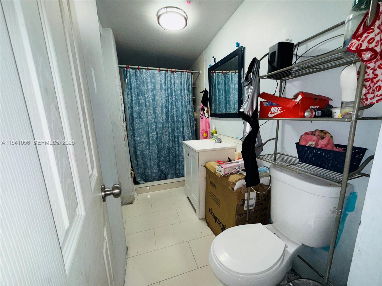 1873 Southwest 3rd Street Miami, FL 33135 - Photo 18 of 18 a bathroom with a toilet a sink and a shower