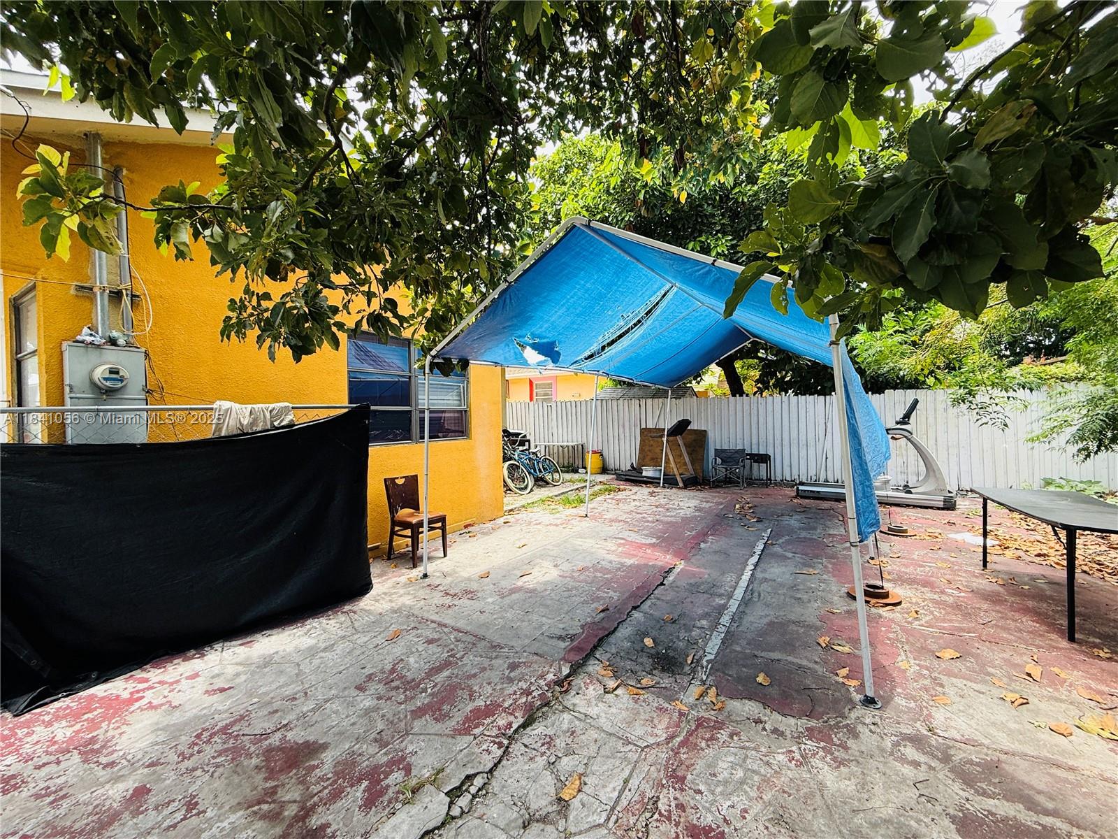 1873 Southwest 3rd Street Miami, FL 33135 - Photo 7 of 18 a wooden bench sitting in front of a house