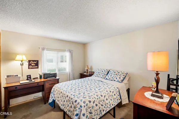 a bedroom with a bed and a desk