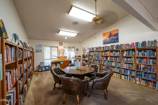 a dining room with furniture and a book shelf