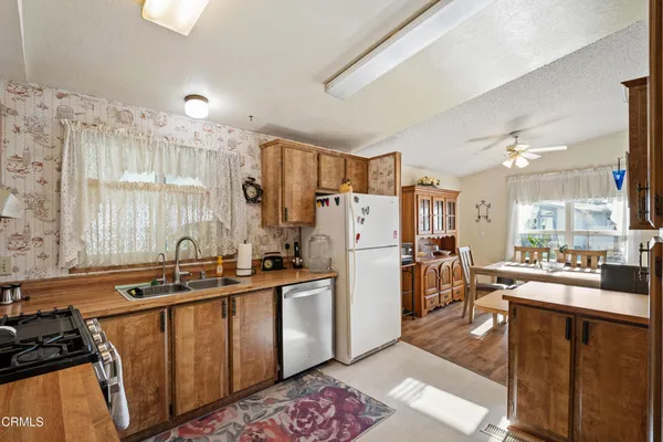 a kitchen with a sink appliances and cabinets