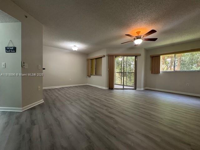 800 Southwest 142nd Avenue, Unit 211N Pembroke Pines, FL 33027 - Photo 11 of 28 an empty room with wooden floor and windows